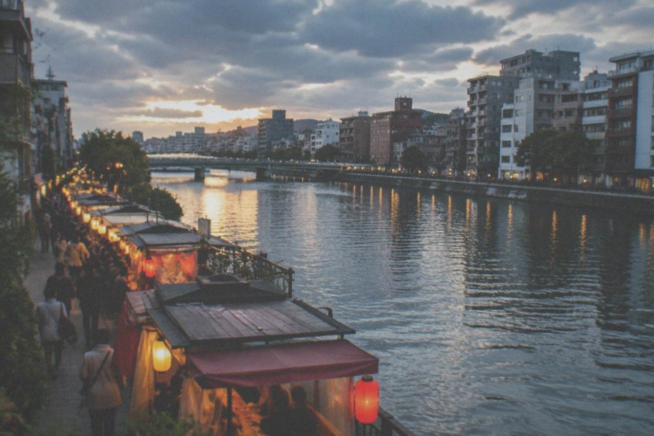 Evening food stalls glowing along the Naka River in the Nakasu district of Fukuoka
