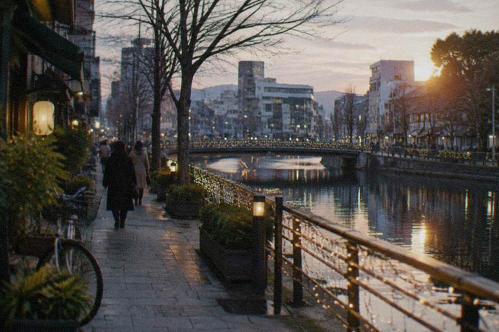 Illuminated winter decorations along a canal in Fukuoka at dusk