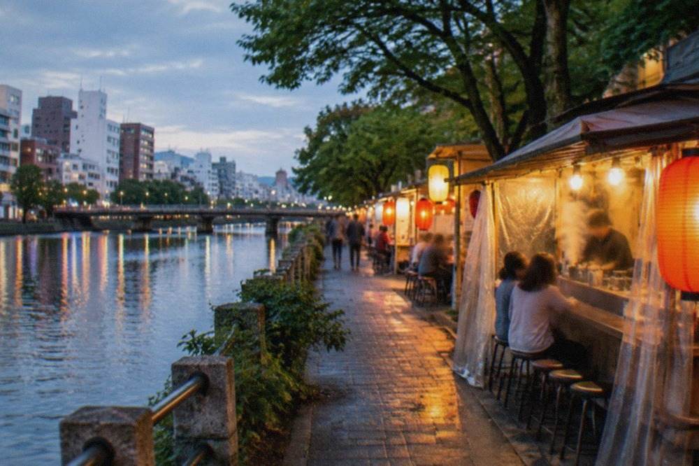 Illuminated street stalls lined up along the Naka River in Fukuoka at night