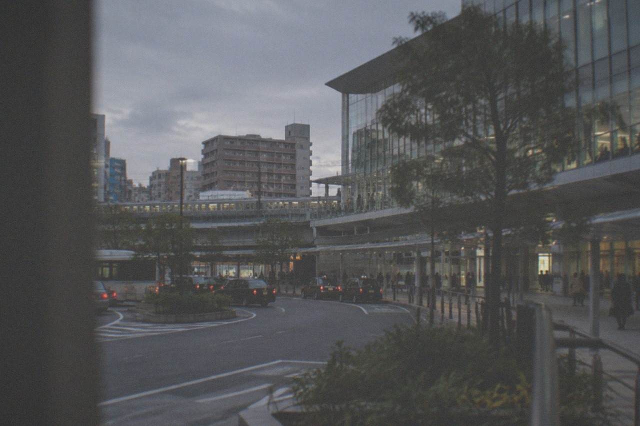 Hakata Station skyline in Fukuoka at dusk with trains and city buildings