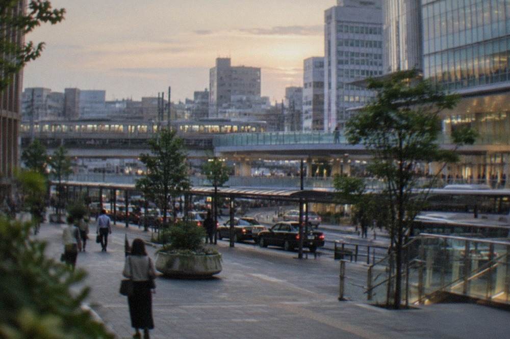 Hakata station district skyline with railway tracks and city buildings at dusk