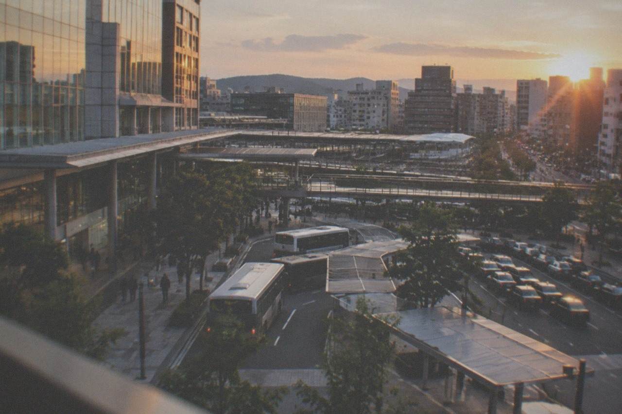 Hakata station district skyline with railway tracks and city buildings at dusk