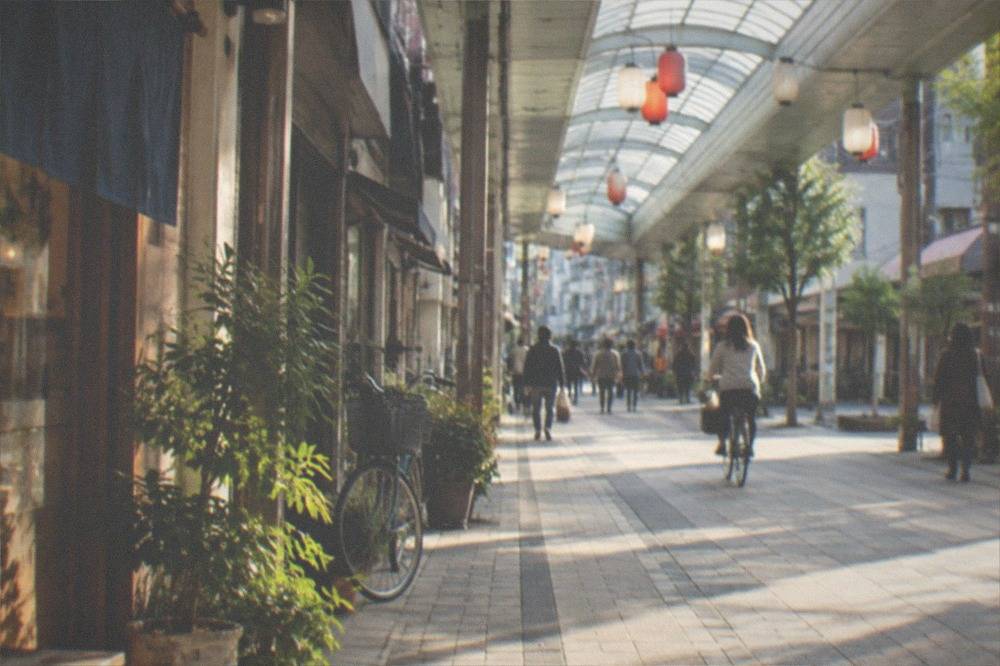 A covered shopping arcade with lanterns hanging from the ceiling