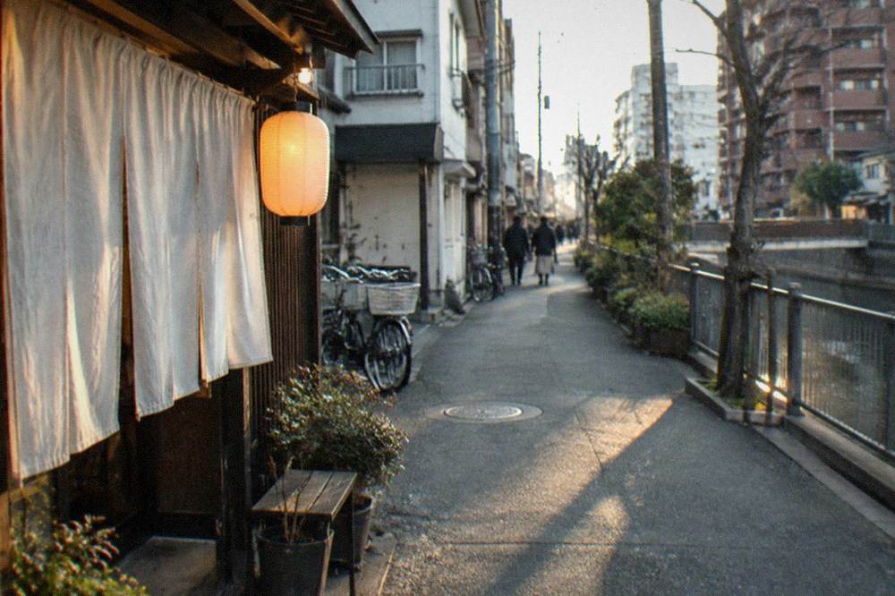A narrow lane in Yakuin with small restaurants and warm evening light
