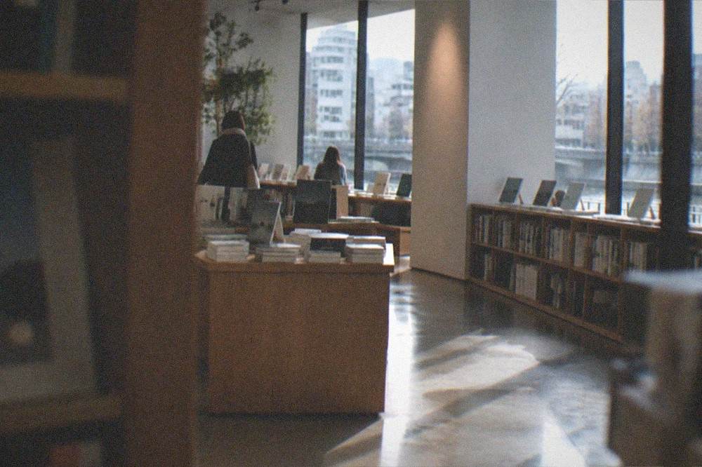 Museum bookshop interior with art books displayed on wooden shelves
