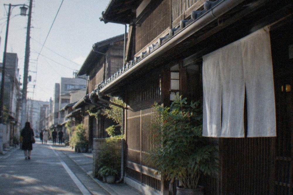 Restored traditional wooden machiya townhouses along a quiet street in Hakata, Fukuoka