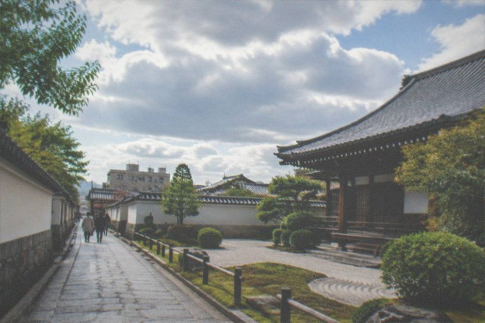 Narrow old street with stone paving leading toward a temple wall
