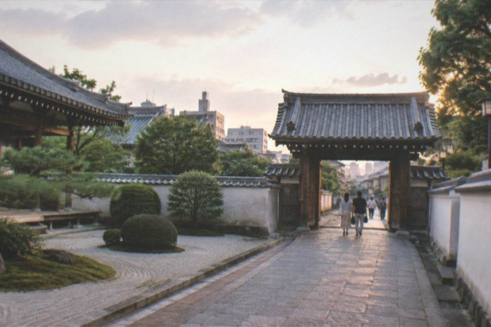 Temple gate in soft evening light with a quiet stone street