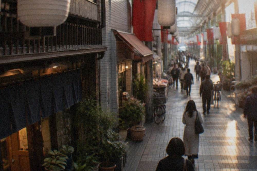 Covered shopping arcade street in Hakata with paper lanterns hanging from the ceiling and small shopfronts on both sides