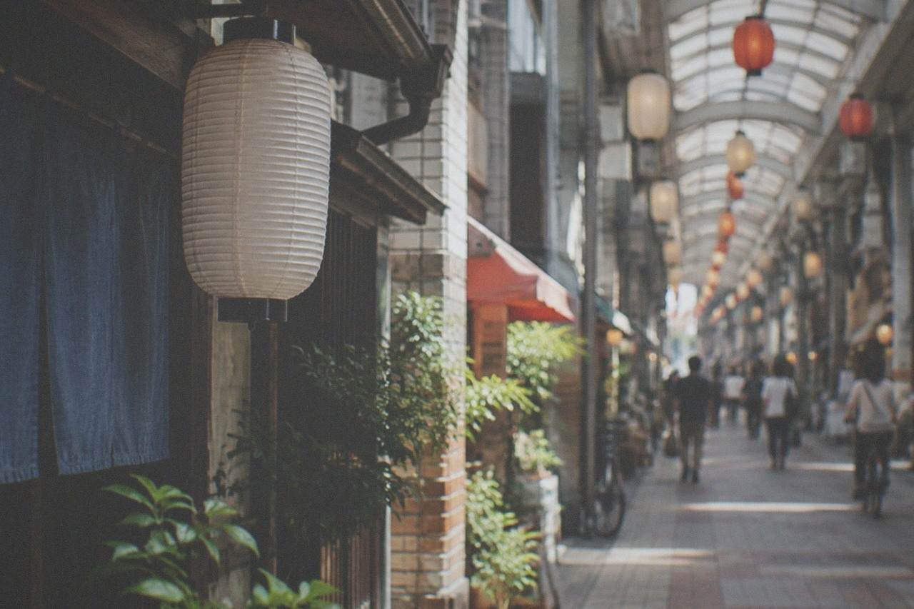 Covered shopping arcade street in Hakata with lanterns hanging from the ceiling and small shopfronts on both sides