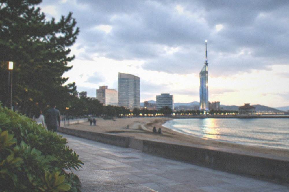 Evening promenade with illuminated tower and lit water