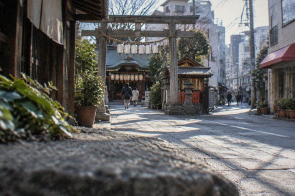 Wooden torii gate at a Hakata shrine with lanterns hanging under the eaves