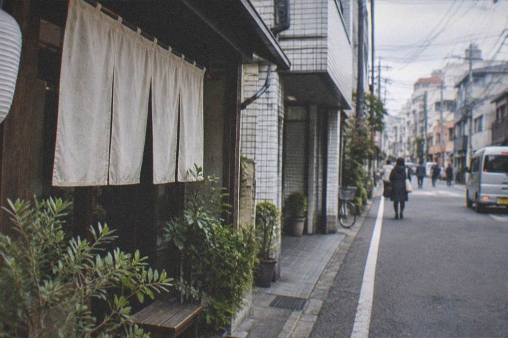 Wooden wish plaques hanging in rows at a Shinto shrine in Hakata