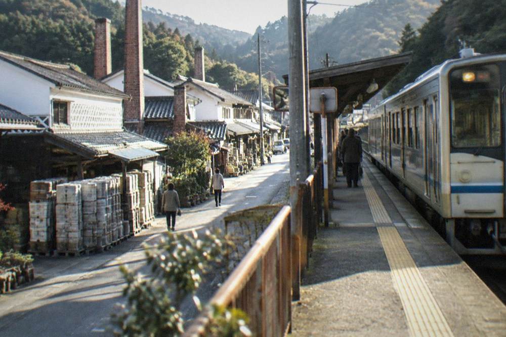 A limited express train stopped at a small rural Japanese station platform