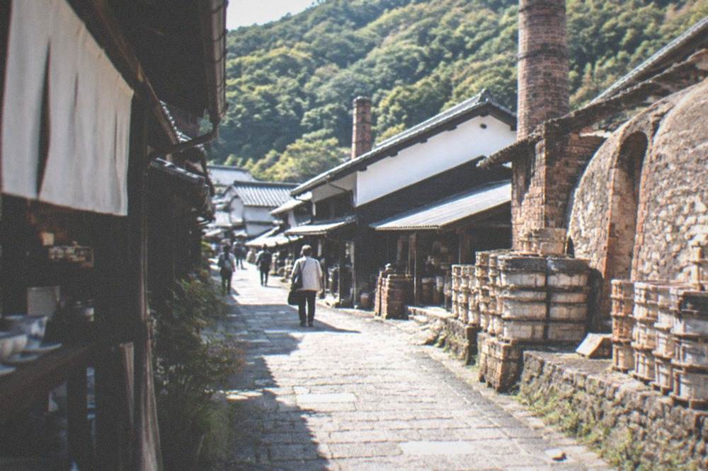 Narrow stone-paved lane between old workshops in a mountain village with kiln brick walls