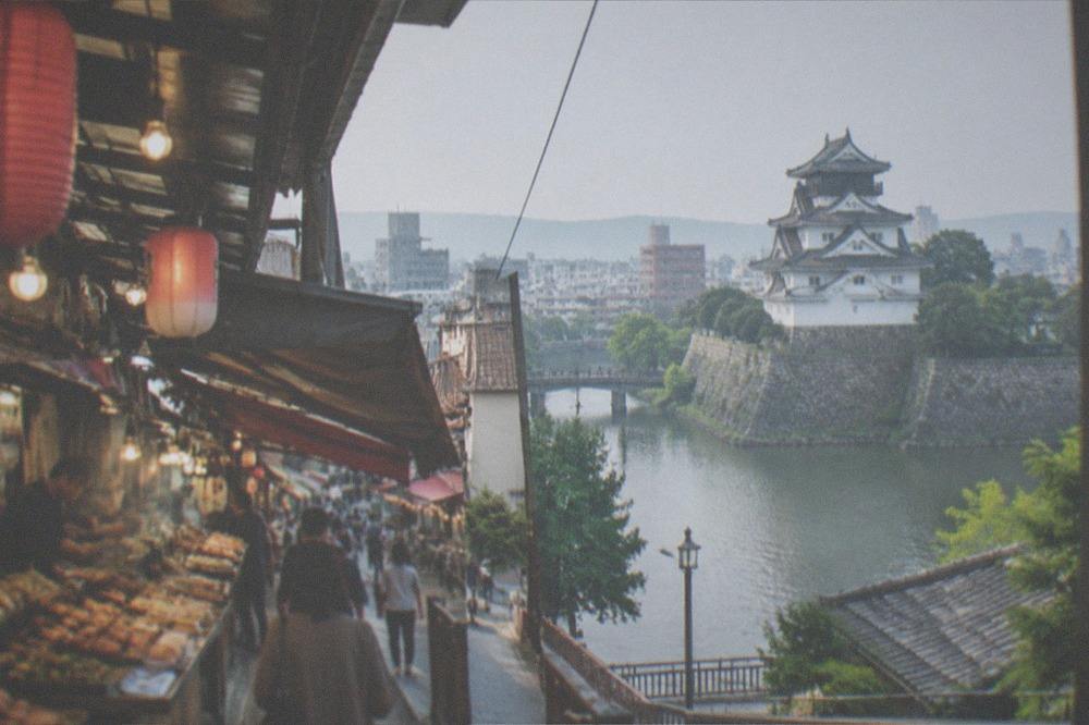 Covered market lane with food stall counters and hanging lanterns