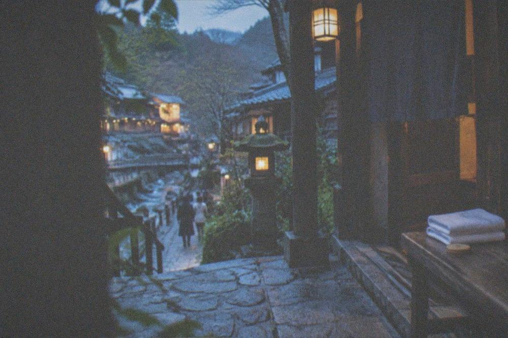 Wooden pass token and folded towels on a bench beside an entrance to a bathhouse