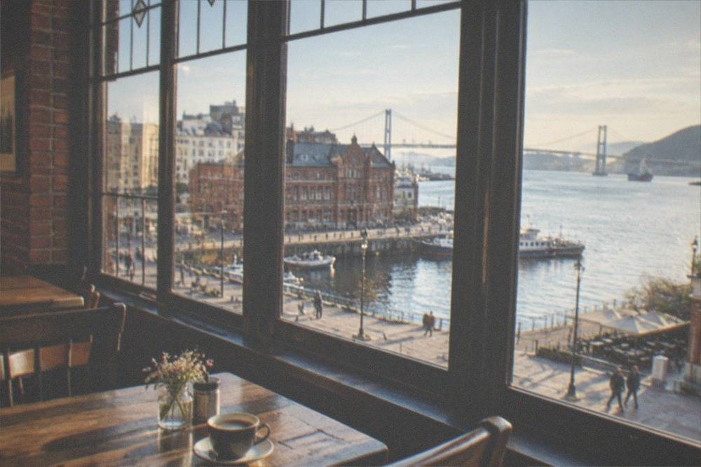 A cosy cafe interior with wooden furniture and leaded windows inside a restored brick building