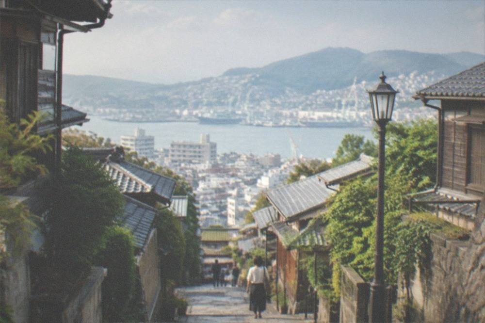 Stone-paved street with historic western-style wooden houses on a hillside
