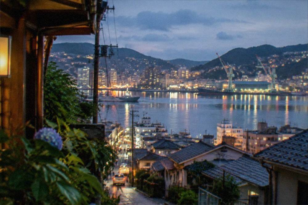 Night view of a harbour with illuminated buildings reflected in calm water