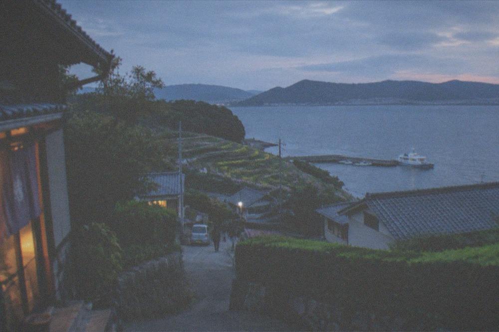 Island village lane with low houses, stone walls and green hedges