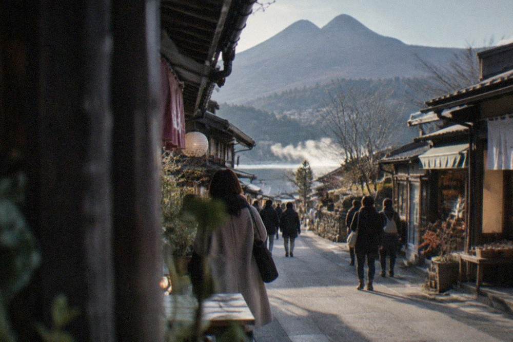 A narrow street lined with small shops and cafes in a mountain valley town