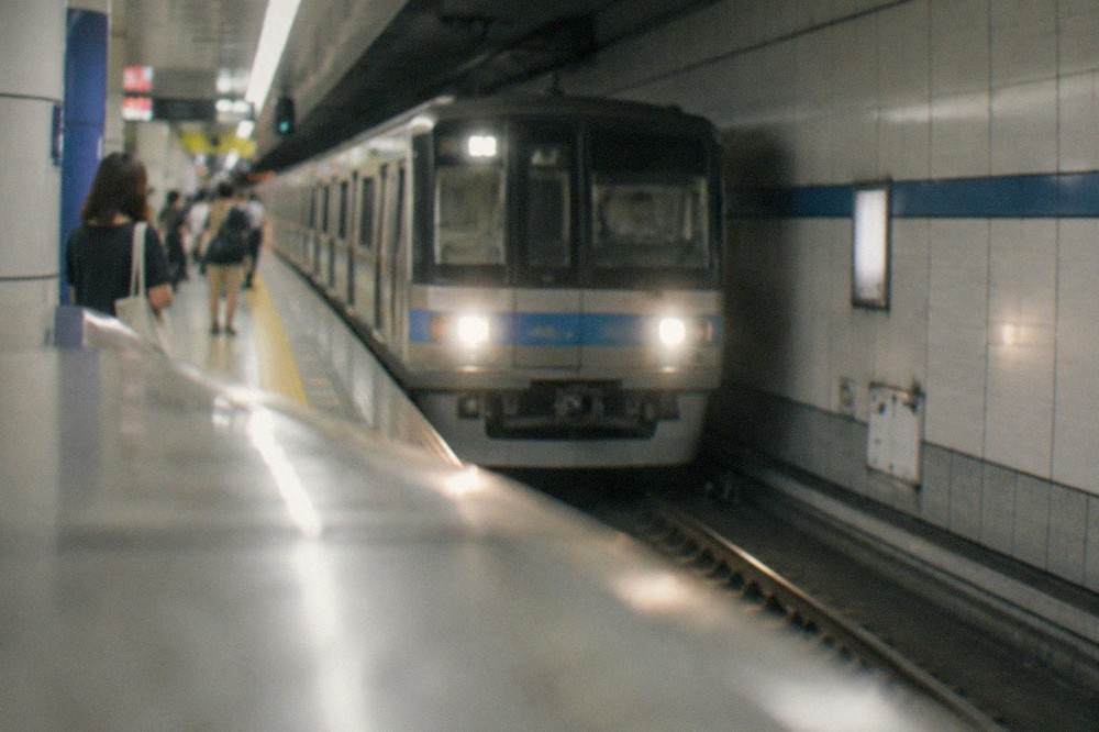 A Fukuoka City Subway train arriving at an underground station platform