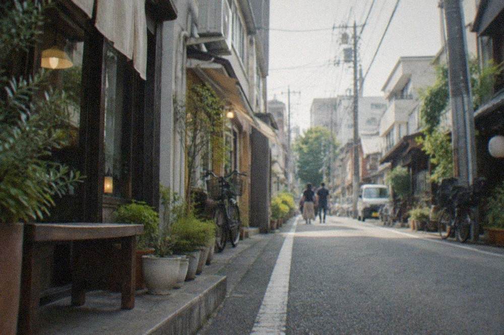 A narrow Daimyo lane lined with small shopfronts and a coffee shop sign among boutiques