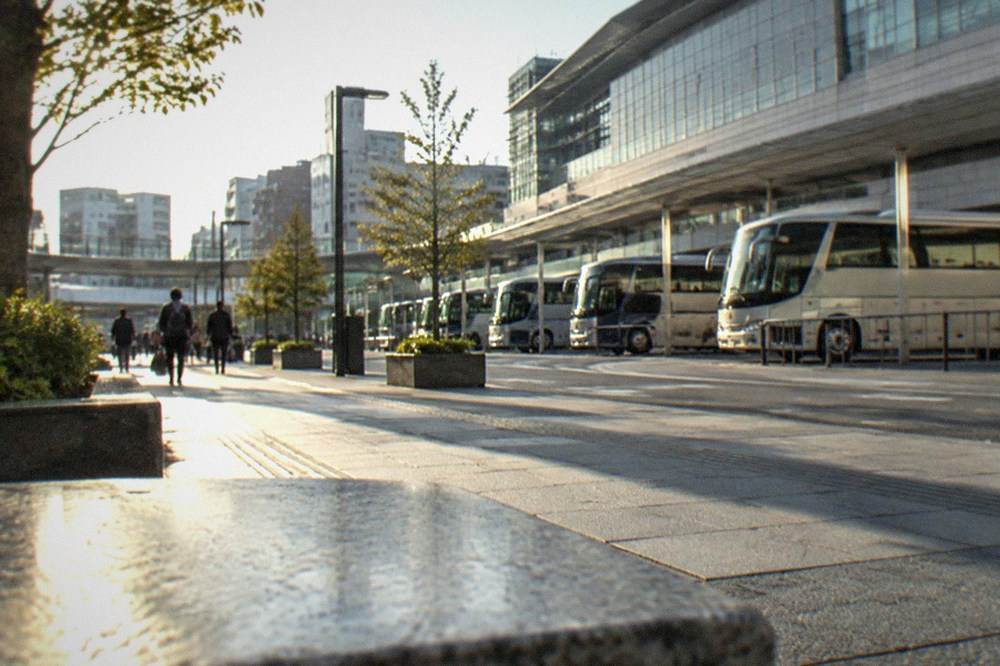 Long-distance tour buses parked in a row at a city bus terminal