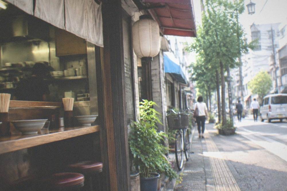 Small ramen shop counter with bowls and chopsticks laid out