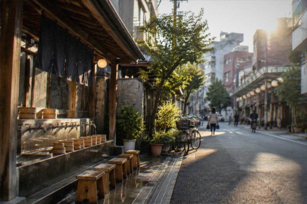 Wooden buckets and stools lined up beside a bathhouse washing area