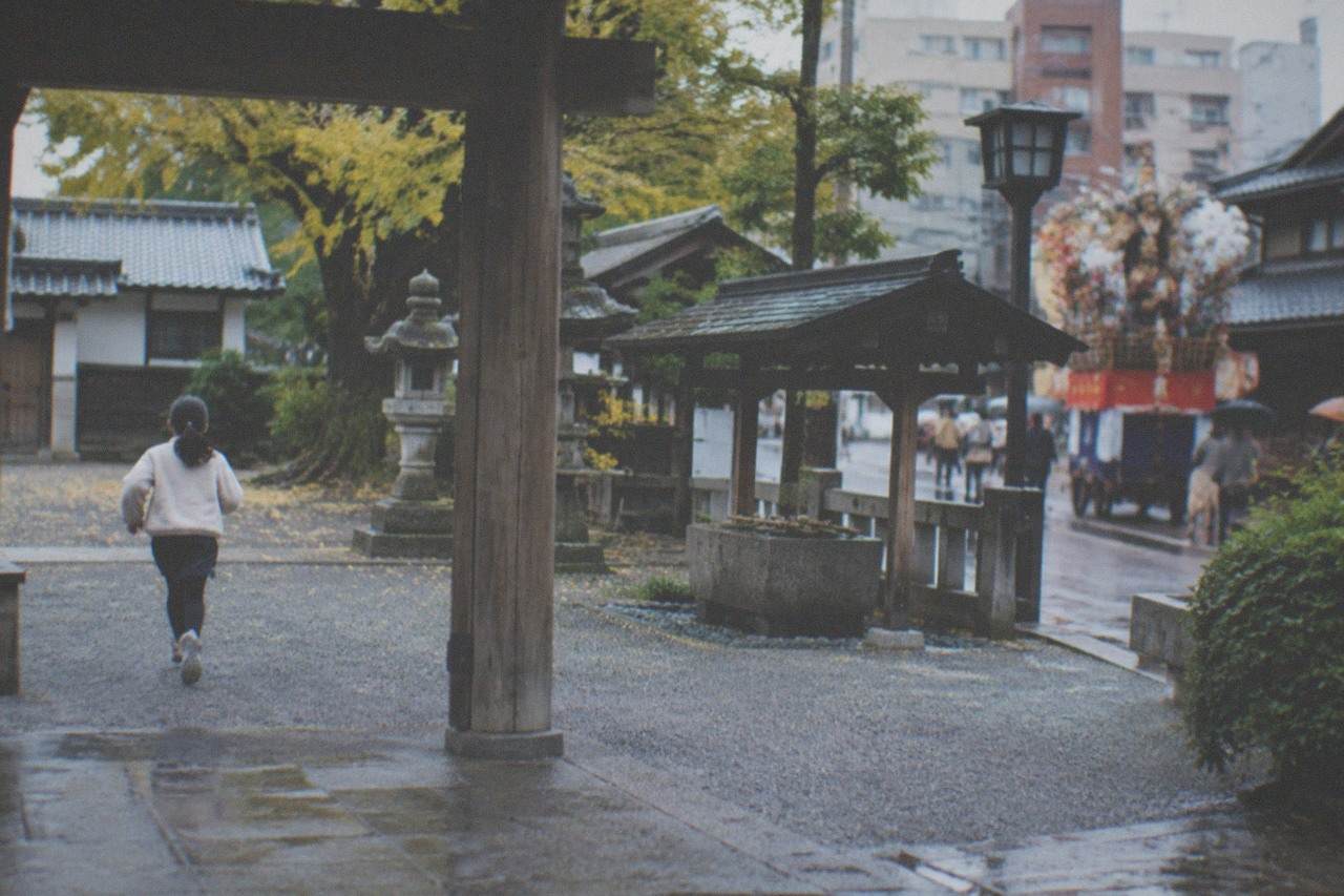 Decorated festival float displayed on a city street in front of traditional buildings