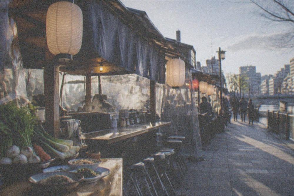 Fresh vegetables and sesame dishes arranged on a small restaurant table