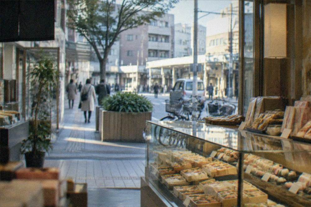 A department store food hall with packaged bento boxes and seasonal sweets arranged in glass counters