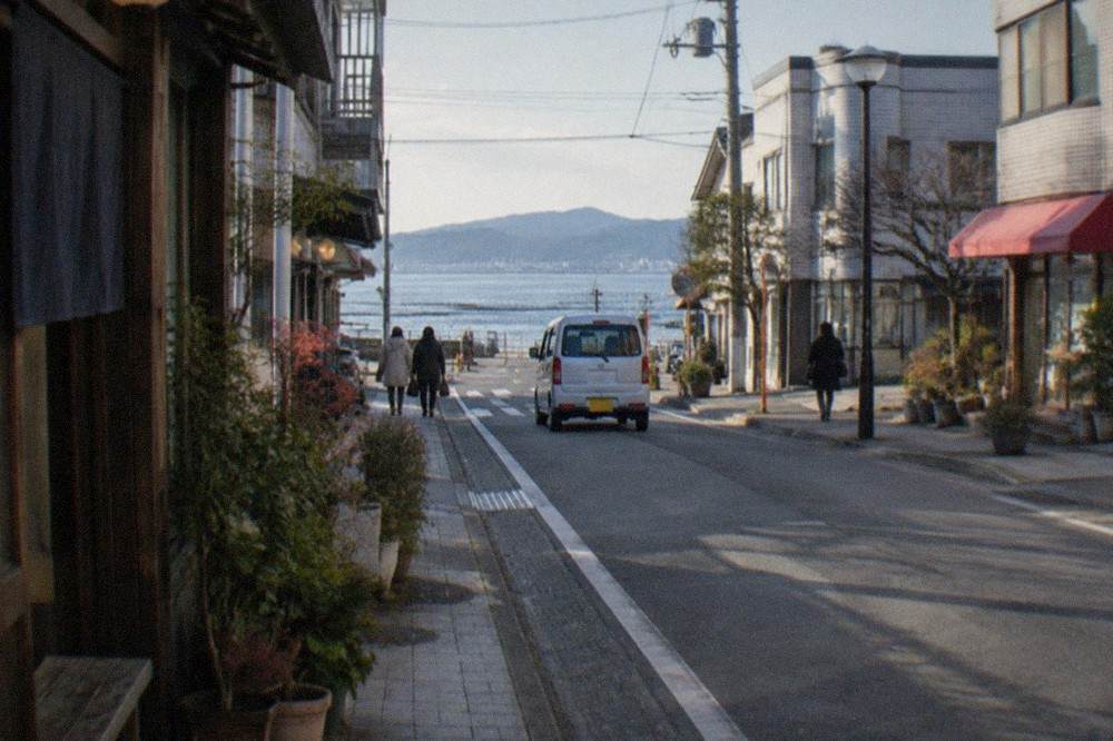 Clear winter morning over Hakata Bay with calm water and distant hills visible across the Genkai Sea