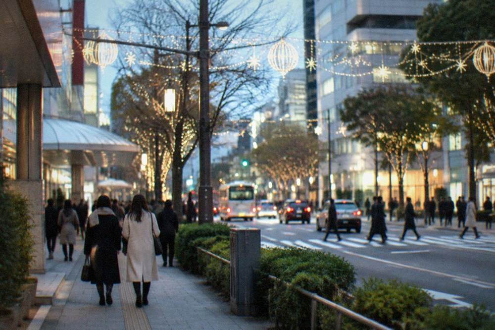 Illuminated winter street in Tenjin with festive light displays hanging between buildings in the evening