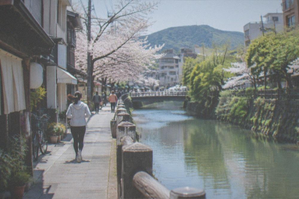 A narrow green gorge with cliffs and a calm river winding between them