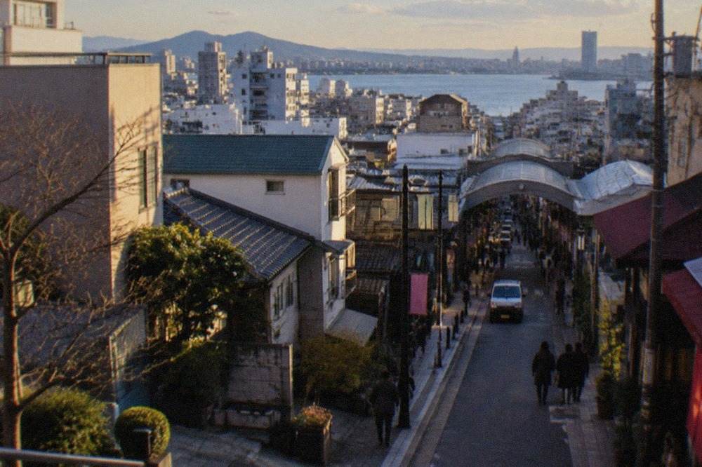 Fukuoka city skyline on a clear winter day with Hakata Bay and distant hills in soft light