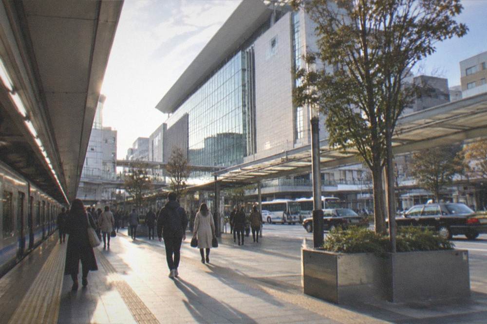 Subway platform at Fukuoka Airport station with a train waiting