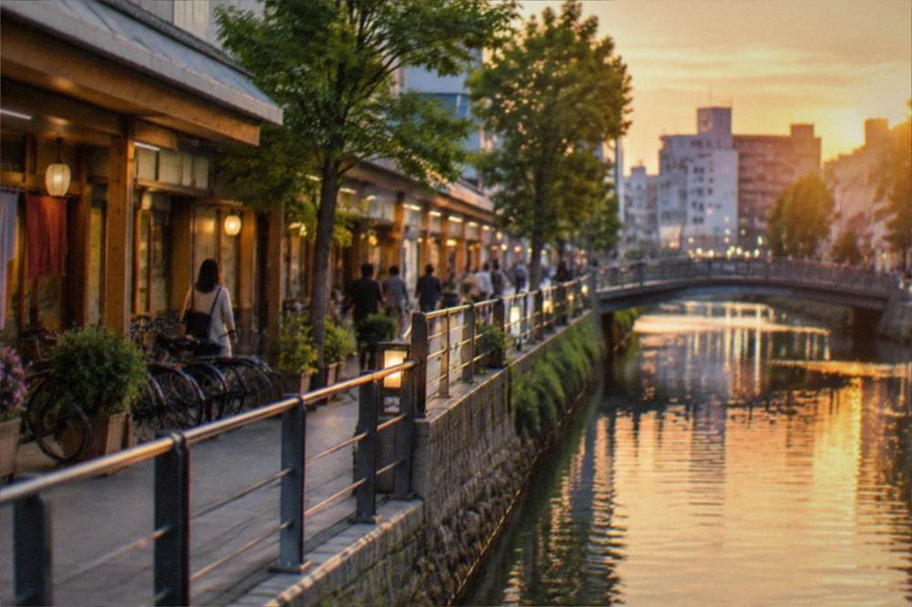 A canal-side shopping complex with illuminated walkways and storefronts in the evening