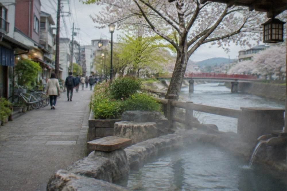 An outdoor hot spring bath steaming in cold air beside a river in a mountain village