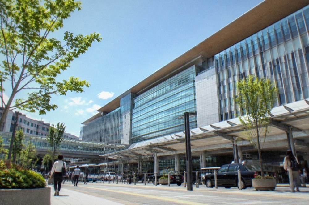 Modern airport terminal concourse with signage above a quiet walkway