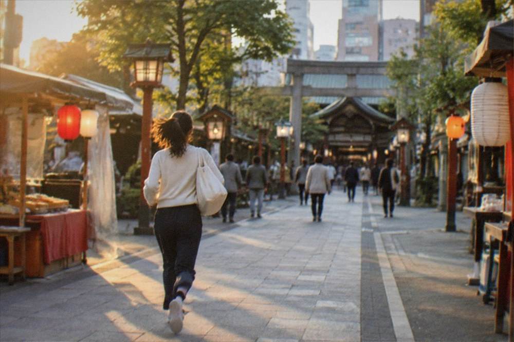 Traditional shopping street approach to a shrine with lanterns and small food stalls along both sides