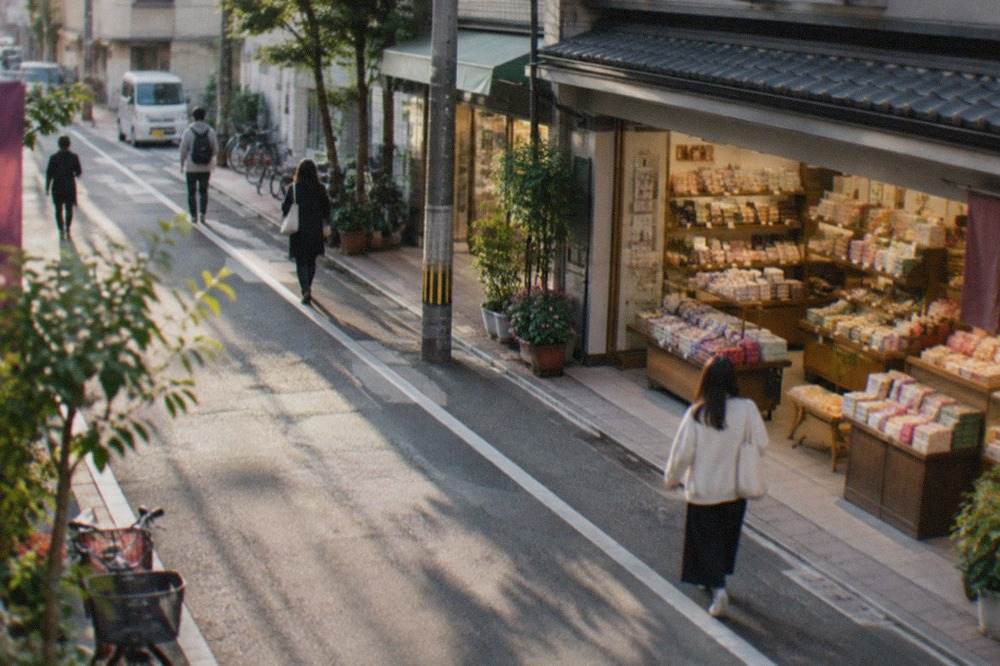 Shelves of packaged food gifts and wrapped boxes inside a brightly lit Japanese souvenir shop