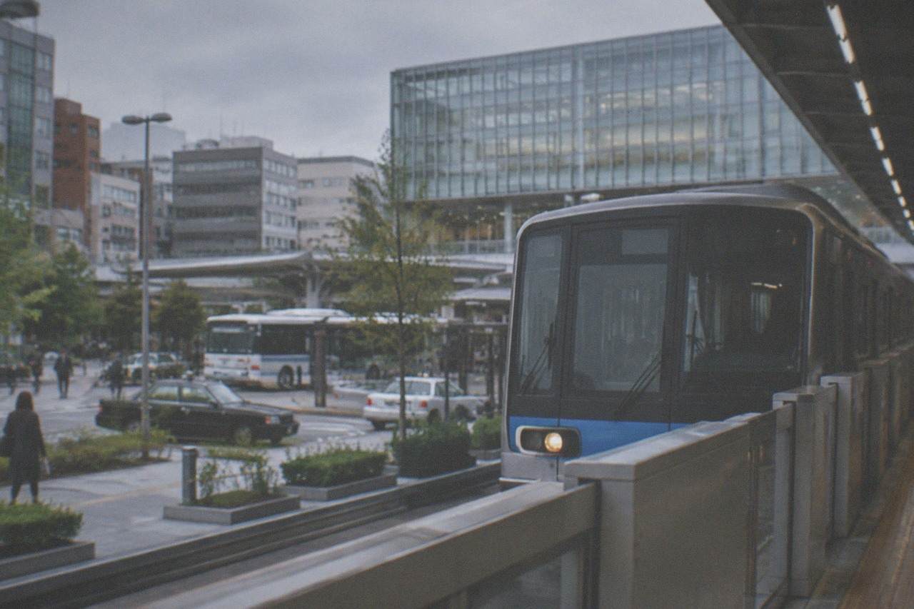 A Fukuoka City Subway train waiting at a platform with illuminated signage