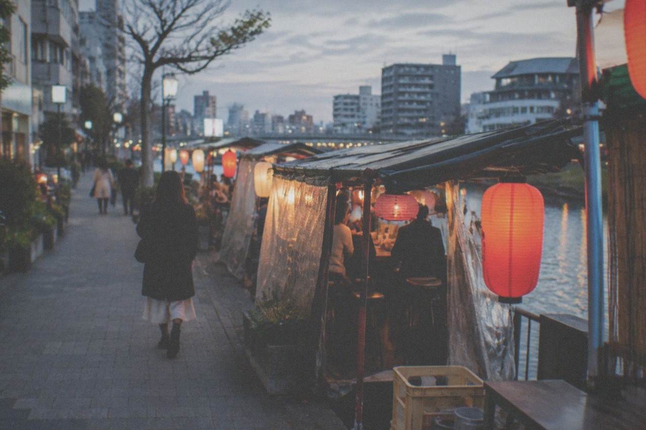 Lantern-lit evening food stalls lined up along the Naka river in Fukuoka