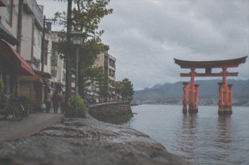 Red torii gate of Itsukushima Shrine standing in the shallow water off Miyajima island