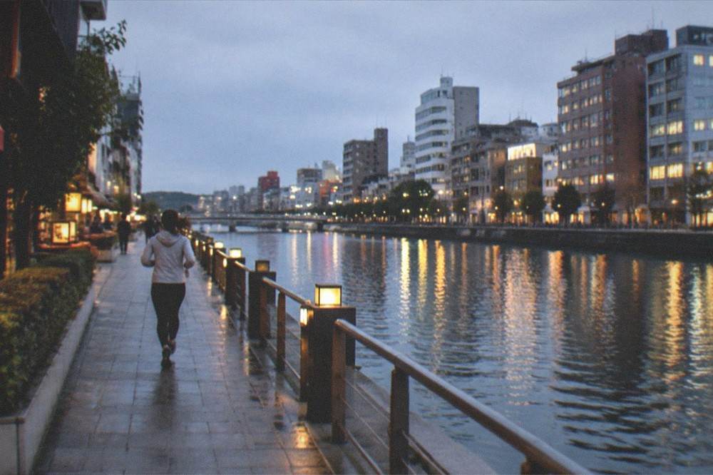Night view of illuminated buildings around the Nakasu entertainment district reflected in the Naka River
