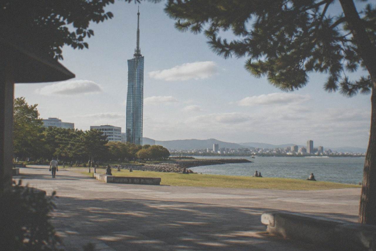 Hakata Bay waterfront at dusk with Fukuoka Tower lit in the distance