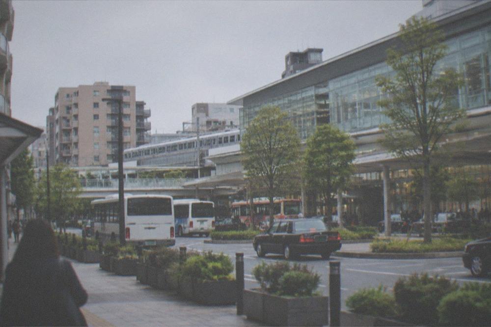Apartment and hotel buildings around a major railway station with trains at the platforms